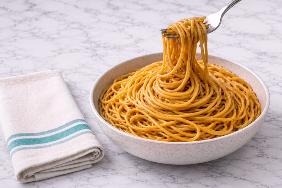 Cold Peanut Noodles in white bowl marble counter top